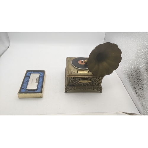 29 - A novelty cigarette lighter and music box fashioned as a gramophone along with a boxed win silver pl... 
