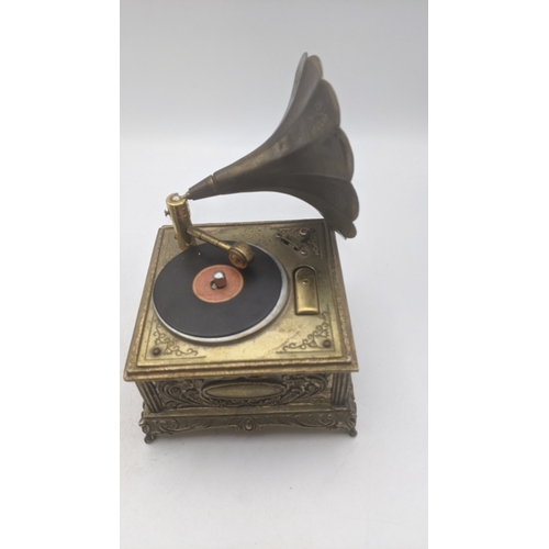 29 - A novelty cigarette lighter and music box fashioned as a gramophone along with a boxed win silver pl... 