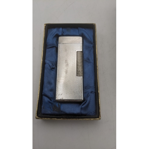 29 - A novelty cigarette lighter and music box fashioned as a gramophone along with a boxed win silver pl... 