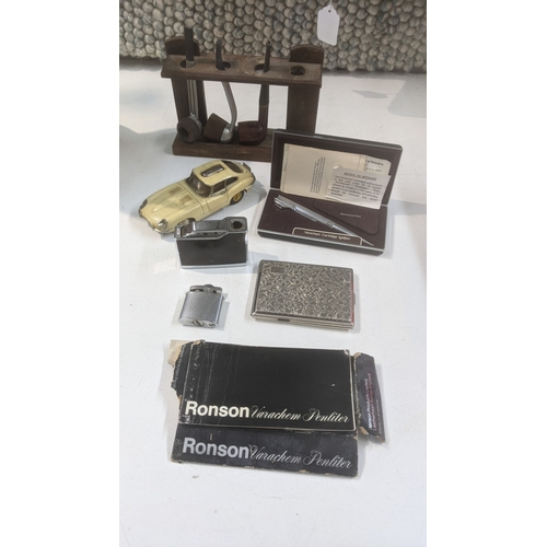 30 - Smoking related items to include a pipe stand with three pipes, a novelty table lighter fashioned as... 