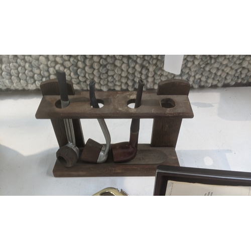 30 - Smoking related items to include a pipe stand with three pipes, a novelty table lighter fashioned as... 