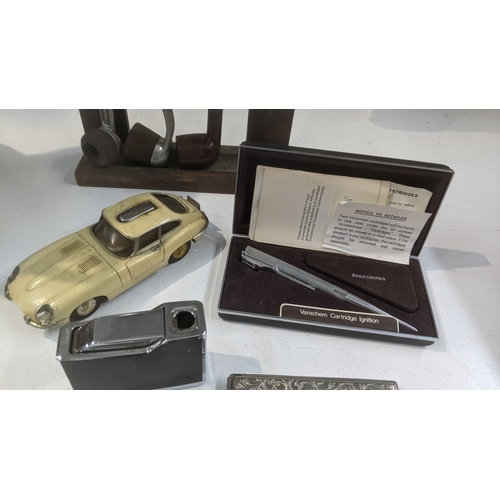 30 - Smoking related items to include a pipe stand with three pipes, a novelty table lighter fashioned as... 
