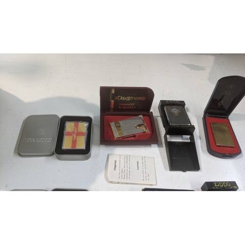 31 - A group of 10 cigarette lighters to include a boxed Piezo electric gold plated example, a boxed King... 