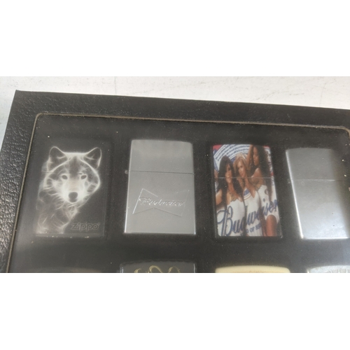 35 - A collection of 20 themed Zippo and Zippo style lighters to include a Rollin Stones Some Girls examp... 