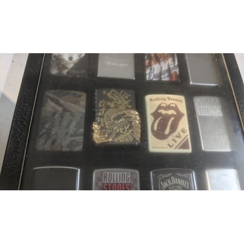 35 - A collection of 20 themed Zippo and Zippo style lighters to include a Rollin Stones Some Girls examp... 