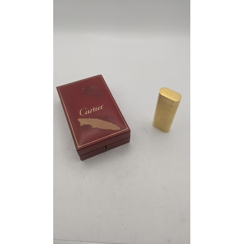 38 - A boxed cartier gold plated cigarette lighter with an engine turned design
Location: C1
If there is ... 
