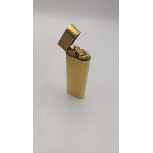 38 - A boxed cartier gold plated cigarette lighter with an engine turned design
Location: C1
If there is ... 