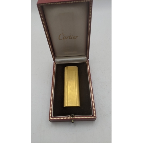 38 - A boxed cartier gold plated cigarette lighter with an engine turned design
Location: C1
If there is ... 