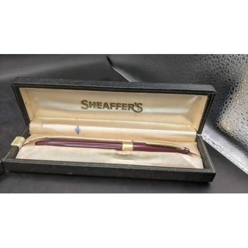 6 - Two boxed vintage Sheaffer fountain pens to include a burgundy cased example with a 14ct gold nib an... 