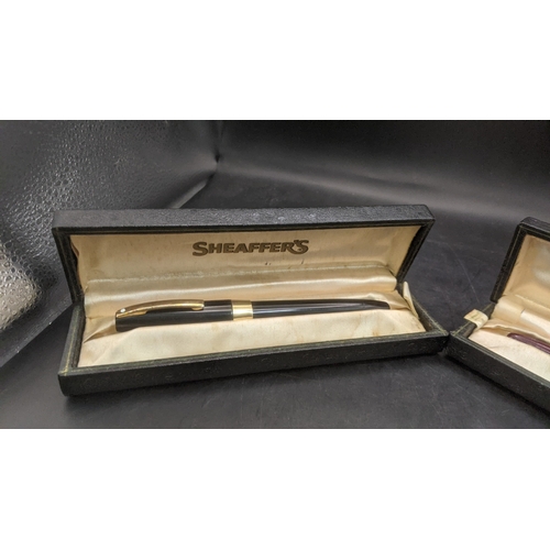6 - Two boxed vintage Sheaffer fountain pens to include a burgundy cased example with a 14ct gold nib an... 
