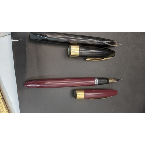 6 - Two boxed vintage Sheaffer fountain pens to include a burgundy cased example with a 14ct gold nib an... 