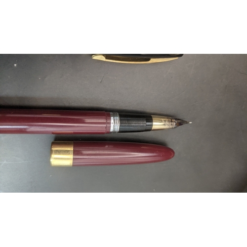 6 - Two boxed vintage Sheaffer fountain pens to include a burgundy cased example with a 14ct gold nib an... 