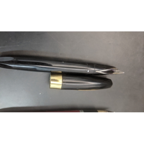 6 - Two boxed vintage Sheaffer fountain pens to include a burgundy cased example with a 14ct gold nib an... 