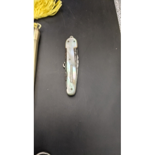 9 - Desktop collectables to include a mother of pearl handled pen knife, a pair of rolled gold cased pro... 