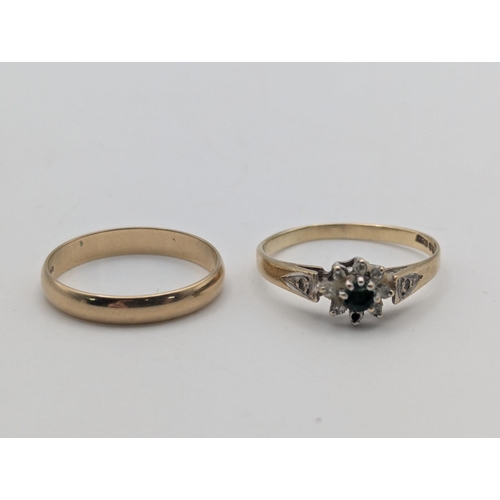 15 - Two 9ct yellow gold rings to include a wedding band size L along with a cluster ring set with an eme... 