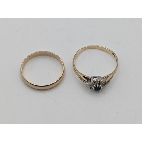 15 - Two 9ct yellow gold rings to include a wedding band size L along with a cluster ring set with an eme... 