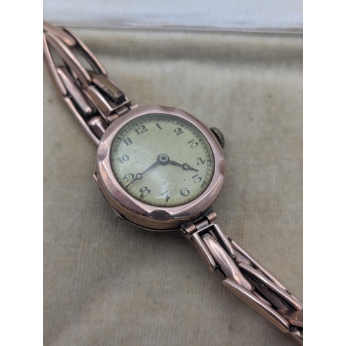 19 - An early 20th century ladies 9ct rose gold cased wristwatch on a 9ct gold expanding bracelet with la... 