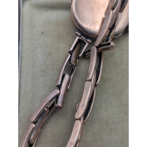19 - An early 20th century ladies 9ct rose gold cased wristwatch on a 9ct gold expanding bracelet with la... 