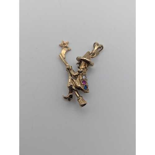 2 - A 9ct yellow gold flying witch pendant set with coloured stones having articulated limbs and broom s... 