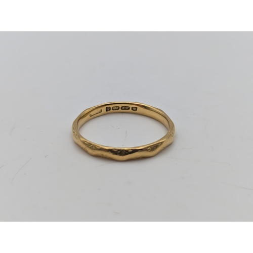 26 - A 22ct yellow gold wedding ring with engraved decoration, size P, weight 2.9g
Location:R1
If there i... 