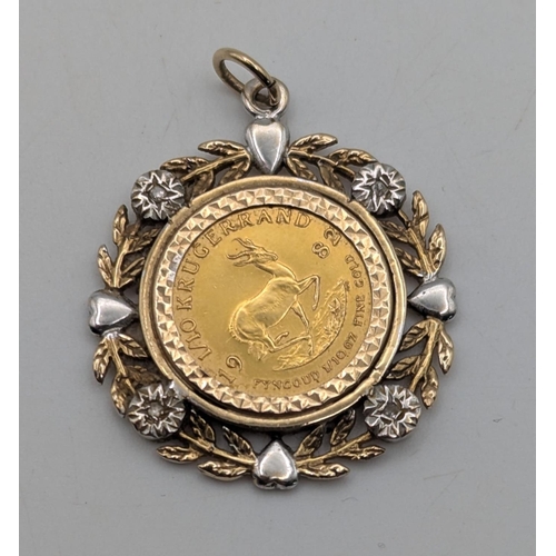 3 - A South African Krugerrand gold coin mounted in a 9ct yellow and white gold diamond set pendant with... 