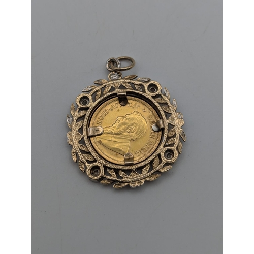 3 - A South African Krugerrand gold coin mounted in a 9ct yellow and white gold diamond set pendant with... 