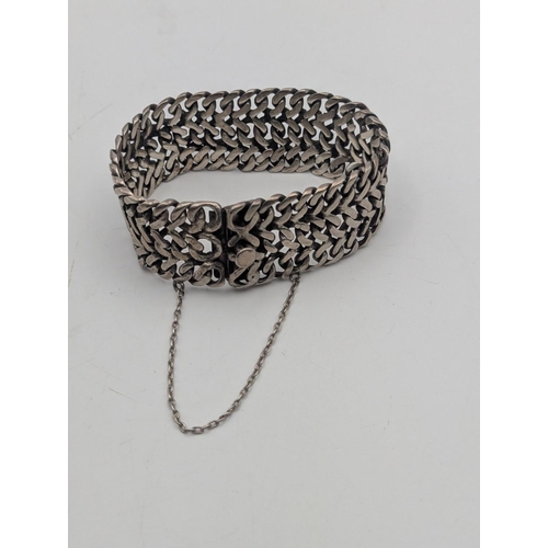 32 - A Mexican silver double curb link woven thick gauge bracelet with box link clasp and safety chain, w... 
