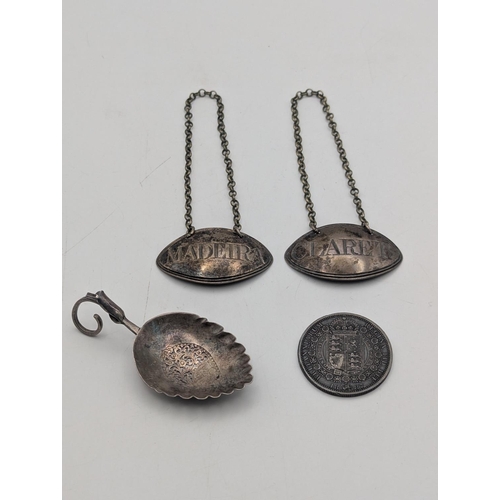 33 - A pair of silver decanter labels to include Madeira and Claret, together with a 1887 silver half cro... 