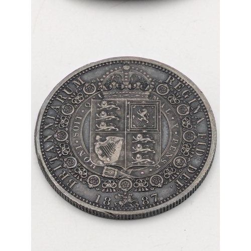 33 - A pair of silver decanter labels to include Madeira and Claret, together with a 1887 silver half cro... 