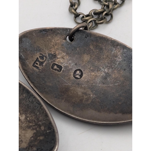 33 - A pair of silver decanter labels to include Madeira and Claret, together with a 1887 silver half cro... 