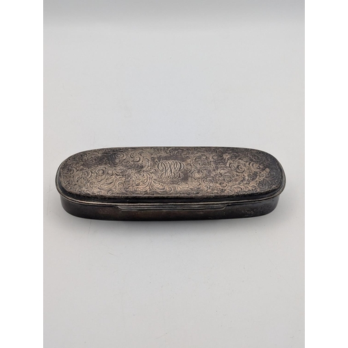 34 - A sterling silver tobacco box in oblong form, floral scroll engraved decoration with initials to the... 