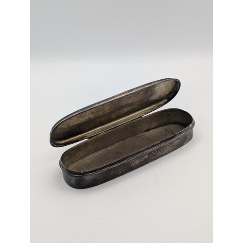 34 - A sterling silver tobacco box in oblong form, floral scroll engraved decoration with initials to the... 