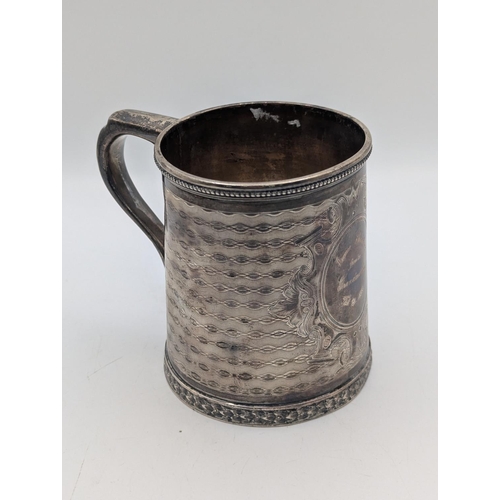 35 - A sterling silver tankard by Tiffany and Co having engine turned decoration with central multi-layer... 