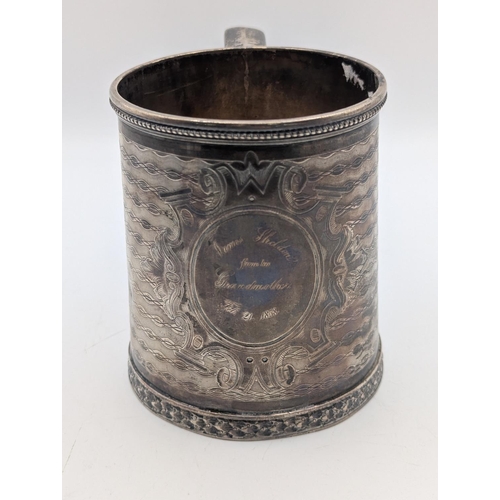 35 - A sterling silver tankard by Tiffany and Co having engine turned decoration with central multi-layer... 
