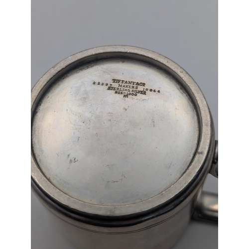 36 - A sterling silver tankard by Tiffany and Co with engraved double line to the base and engraved initi... 