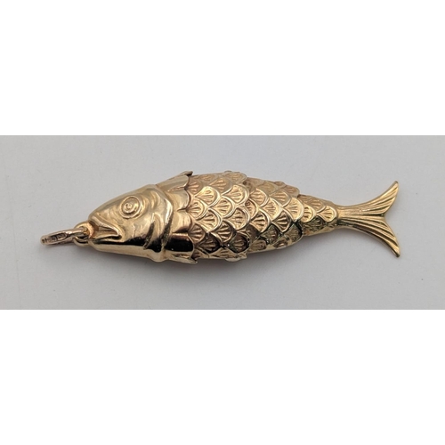 4 - A 9ct yellow gold articulated fish pendant with embossed detail on a suspension loop 45mm L, 3.2g
Lo... 