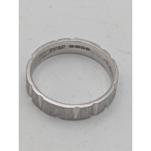 45 - An 18ct white gold wedding band with textured design, size L, weight 3g
Location:R1
If there is no c... 