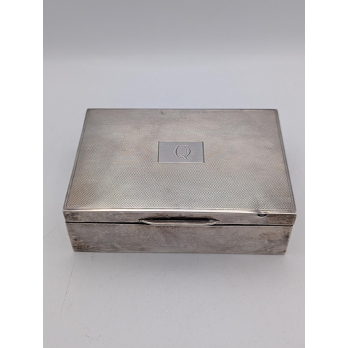 47 - A silver box having an engine turned lid with central cartouche engraved with the initial Q, hallmar... 