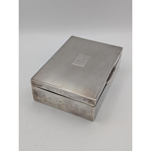 47 - A silver box having an engine turned lid with central cartouche engraved with the initial Q, hallmar... 