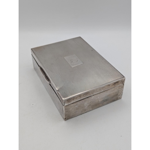 47 - A silver box having an engine turned lid with central cartouche engraved with the initial Q, hallmar... 