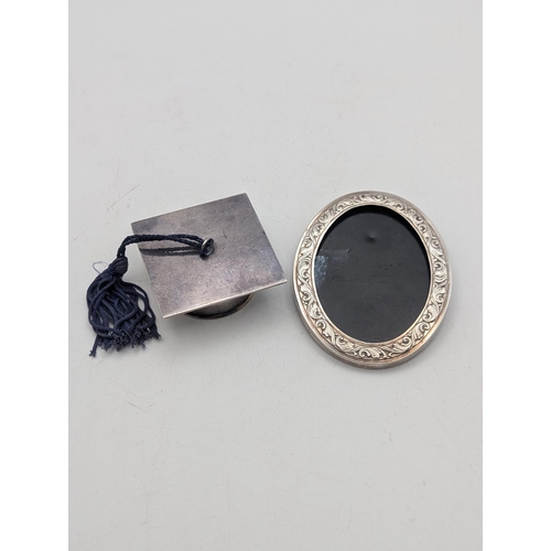 48 - Silver items to include a miniature graduation cap mounted with a 2001 silver Britannica 20p coin to... 