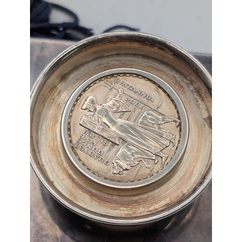 48 - Silver items to include a miniature graduation cap mounted with a 2001 silver Britannica 20p coin to... 