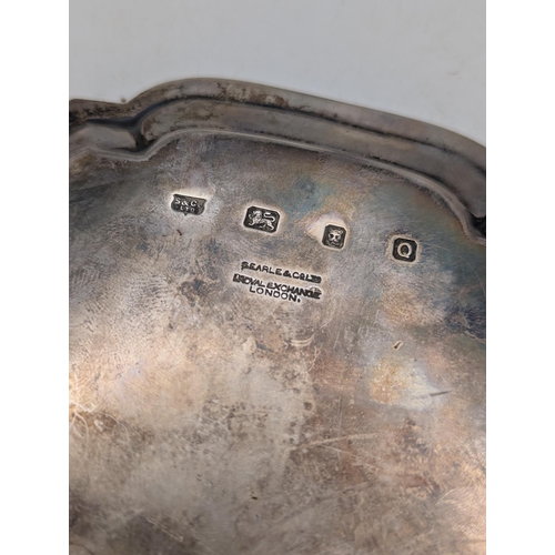 50 - A silver card tray with scalloped border engraved inscription with crest to the centre, hallmarked L... 