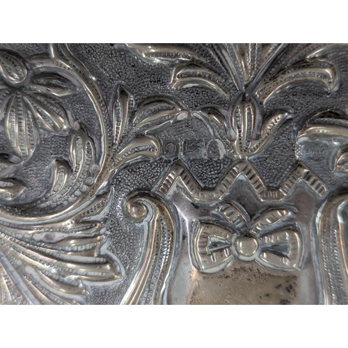 53 - A Mappin and Webb silver dressing table tray having embossed scroll, acanthus leaves decoration with... 
