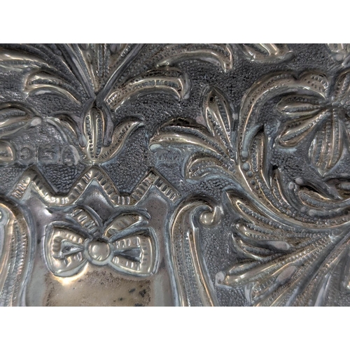 53 - A Mappin and Webb silver dressing table tray having embossed scroll, acanthus leaves decoration with... 