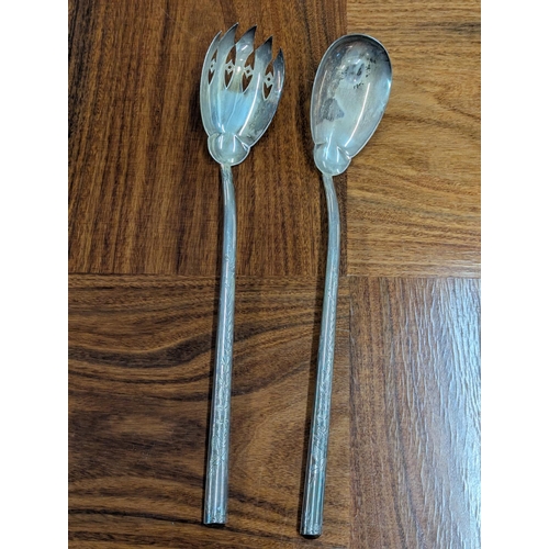 54 - A pair of Victorian salad servers with floral engraved decoration to the base of the bowls and termi... 