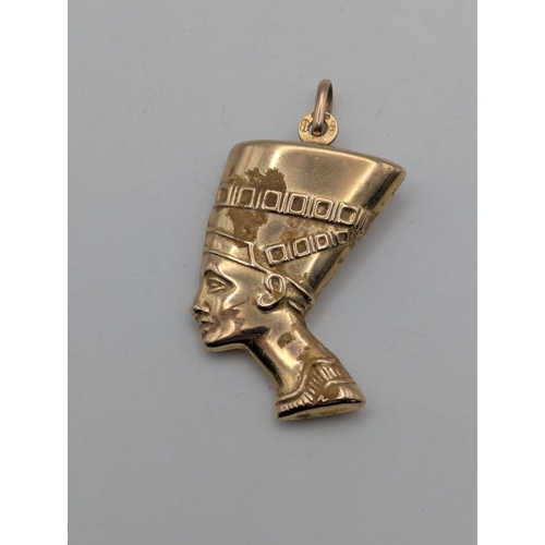 6 - A 9ct yellow gold pendant fashioned as the Egyptian Queen Nefertiti with suspension loop and embosse... 