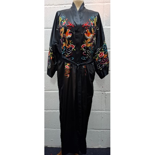 55 - Four late 20th Century Chinese robes to include a gold satin calf length gown having machine embroid... 