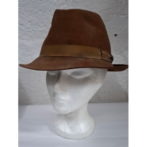 56 - Hats, table linen and throws comprising late 20th Century Jaeger ladies hats, a Bermona Trend black ... 