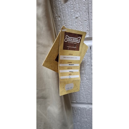 47 - Driza-Bone- An un-worn natural moleskin riding coat having original tags intact, size 6 on label (ap... 